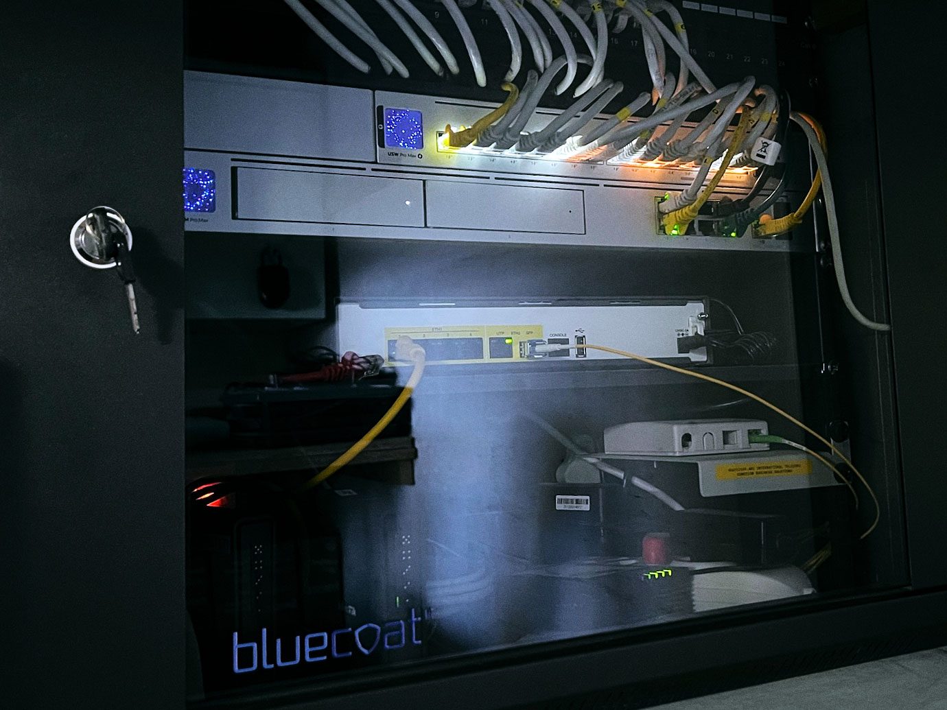 A completed bluecoat IT network cabinet with patching and switching
